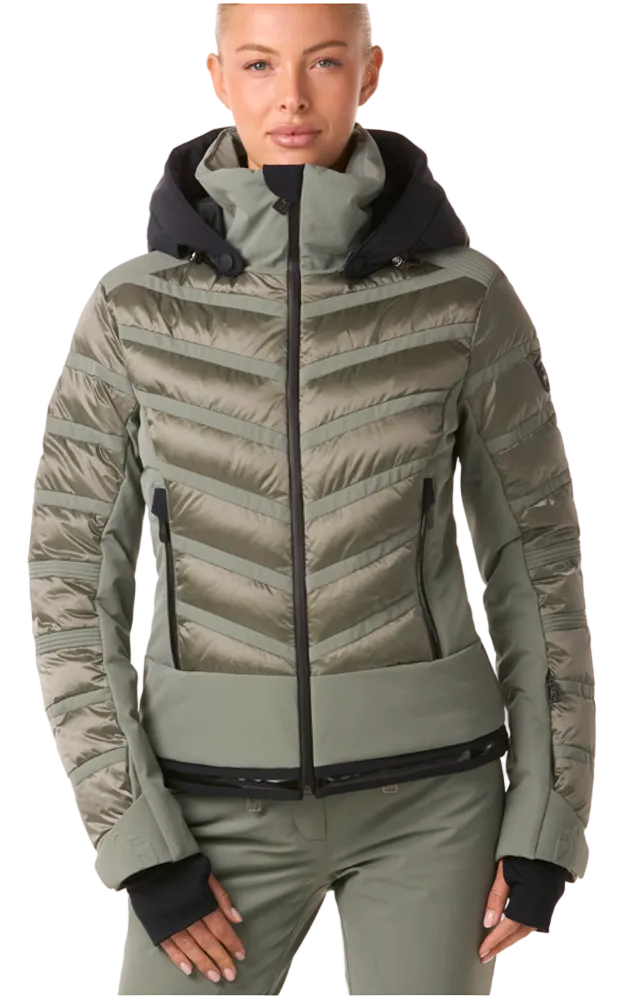 Toni Sailer Women’s Swinta Splendid Jacket showing 4-way stretch fabric with shiny jet-fabric accents, high-loft insulation baffles, YKK AquaGuard water-repellent zippers, forearm ski pass pocket, and elastic wrist gaiters with thumbholes.