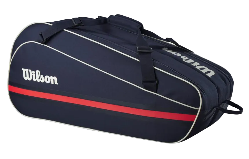 A navy blue Wilson Team 6 Pack racket bag that is designed to hold up to 6 tennis rackets.