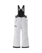 Front view of white Reima Jr Terrie Pants featuring a waterproof Reimatec shell, detachable elastic suspenders, reinforced ankle scuff guards, and internal snow gaiters.