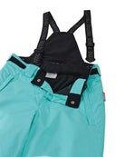 Close-up of aquamarine Reima Jr Terrie Pants featuring a waterproof Reimatec shell, detachable elastic suspenders, reinforced ankle scuff guards, and internal snow gaiters.