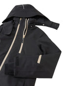 Front view of a black Reima Jr Tieten Jacket featuring a waterproof Reimatec shell, detachable safety hood, zipped sleeve ski pass pocket, and full front zipper storm flap.
