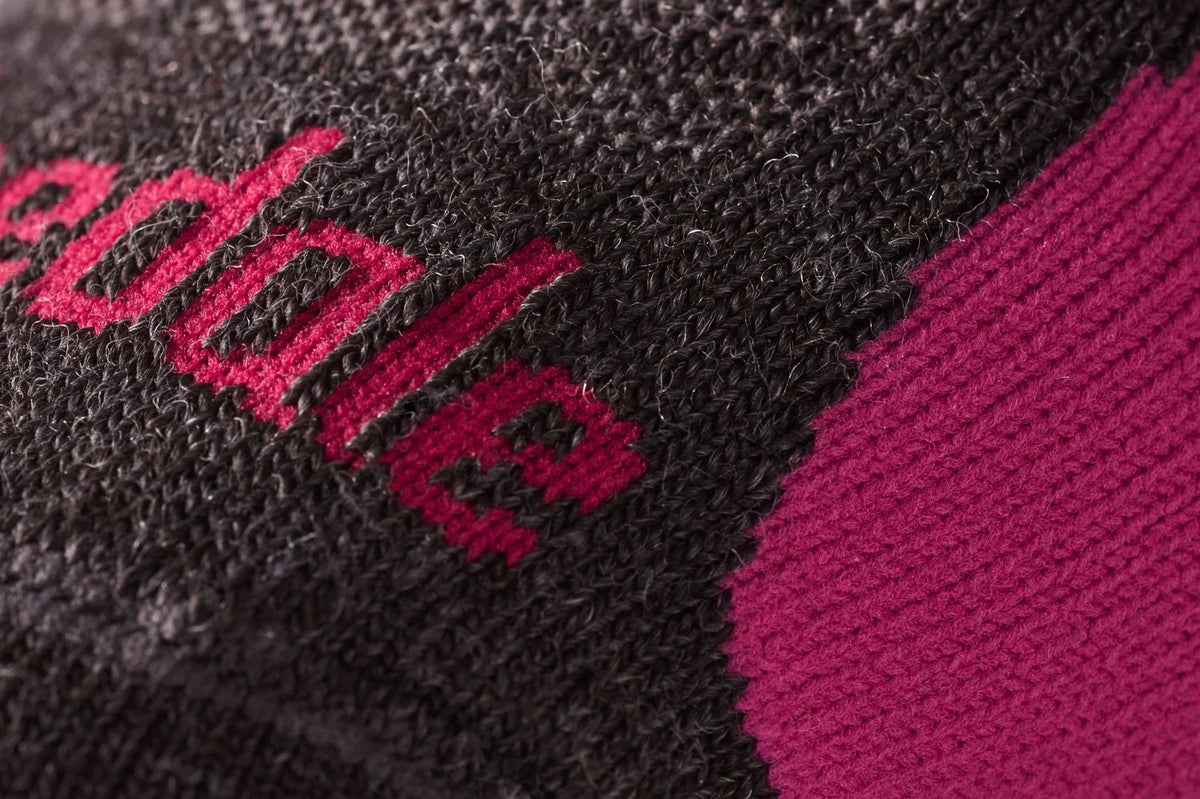 Bridgedale Women's Lightweight Merino Performance Over Calf ski sock with MerinoFusion construction and targeted foot and shin cushioning.