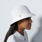 A woman wearing a Daily Sports  Dubbo ladies' golf hat with a narrow brim, in profile against a white background.