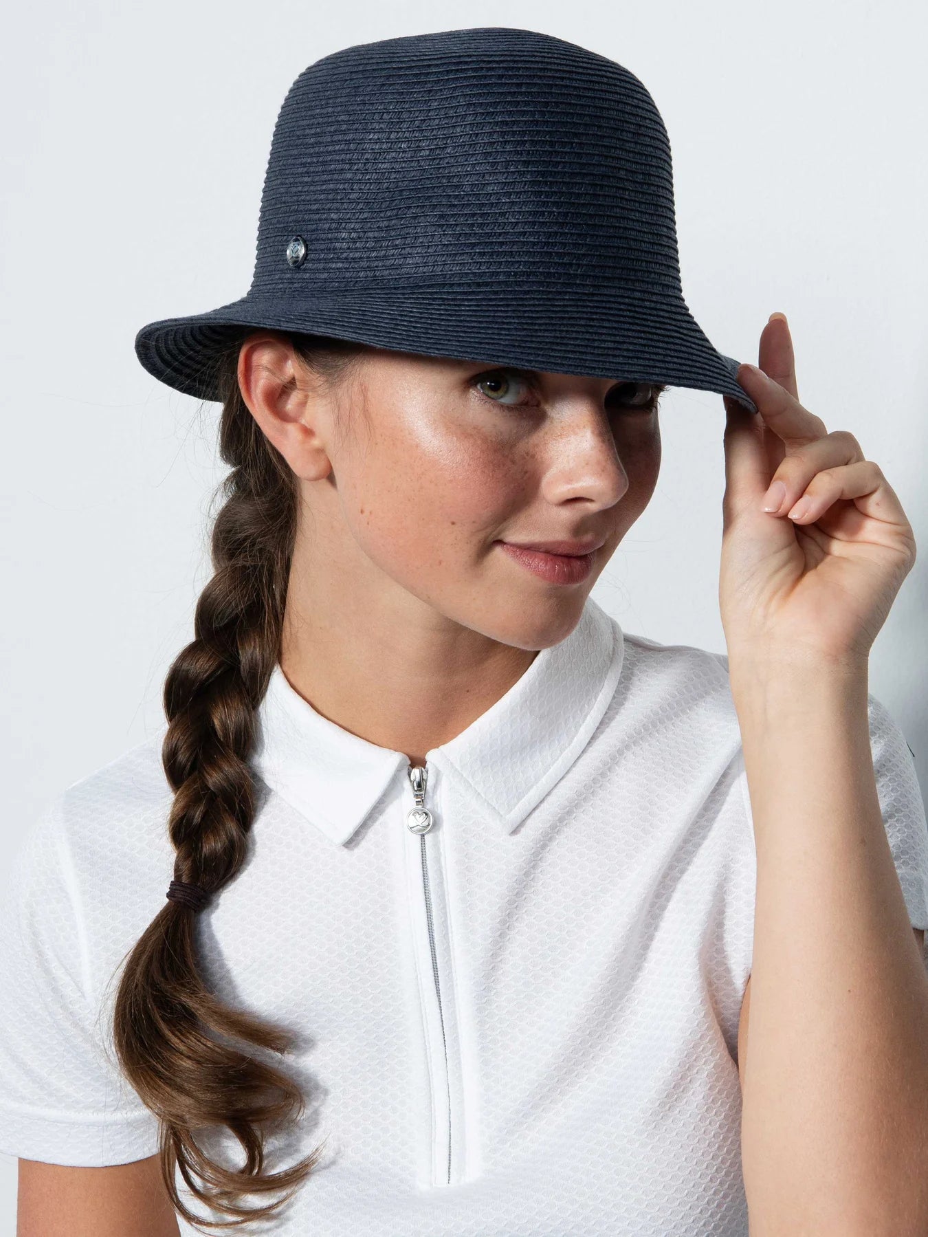 A woman wearing a Daily Sports  Dubbo ladies' golf hat with a narrow brim, in profile against a white background.