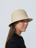 A woman wearing a Daily Sports  Dubbo ladies' golf hat with a narrow brim, in profile against a white background.