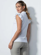 A woman wearing a Daily Sports Women's Albi Sleeveless Polo Shirt on a white background