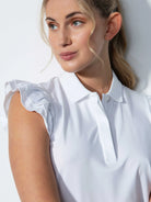 A woman wearing a Daily Sports Women's Albi Sleeveless Polo Shirt on a white background