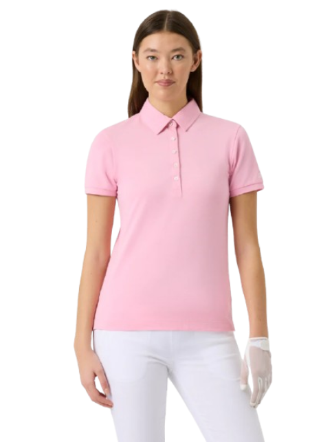 Woman wearing a pink Daily Sports Fairway shortsleeve polo shirt and white pants on a white background