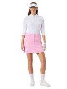 Woman in Daily Sports golf attire with a white shirt, pink skirt, and white visor on a white background