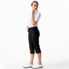 A woman wearing black Daily Sports Women’s Lyric 29" Golf Capris on a white background