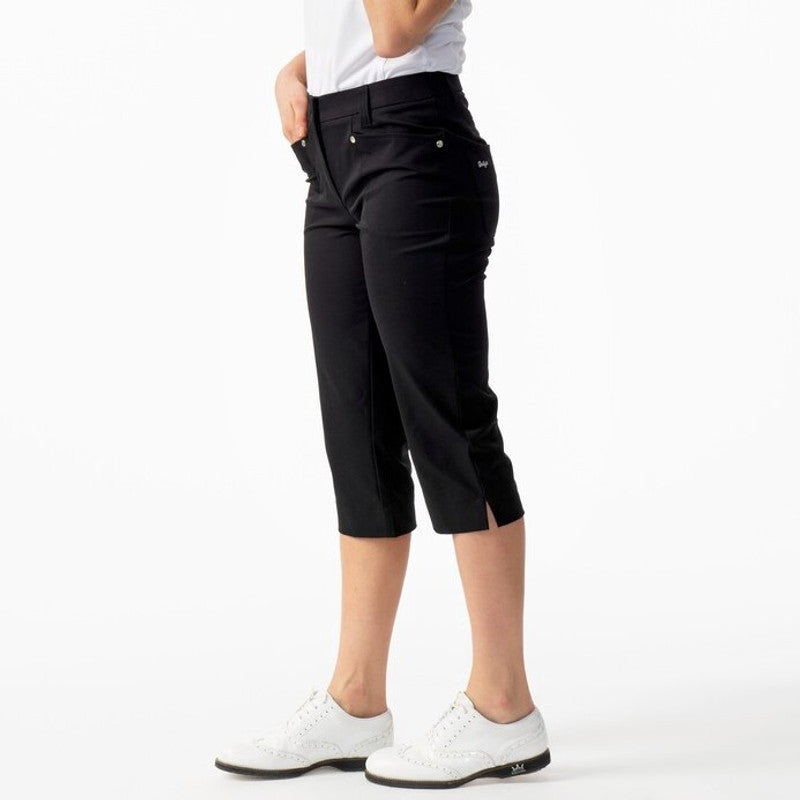 A woman wearing black Daily Sports Women’s Lyric 29" Golf Capris on a white background