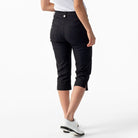 A woman wearing black Daily Sports Women’s Lyric 29" Golf Capris on a white background