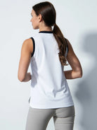 A woman wearing a white Daily Sports Women's Massy Sleeveless Polo Shirt on a white background