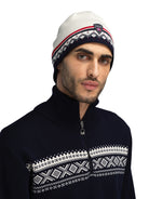 A man wearing an off-white and navy Dale of Norway Moritz Hat that is made in Norway from luxurious Norweigan wool.