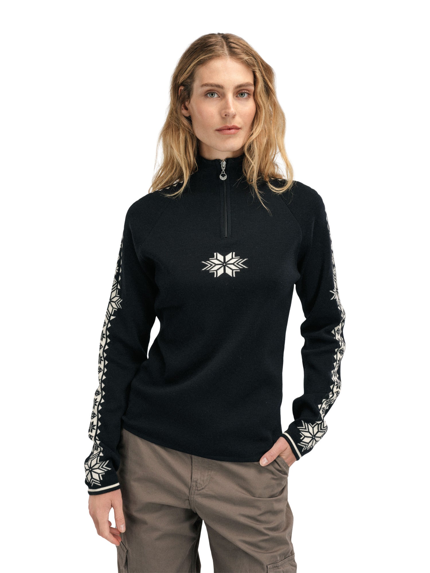 A woman wearing a black Dale of Norway Women’s Geilo turtleneck sweater made in Norway from luxurious Norweigan merino wool.