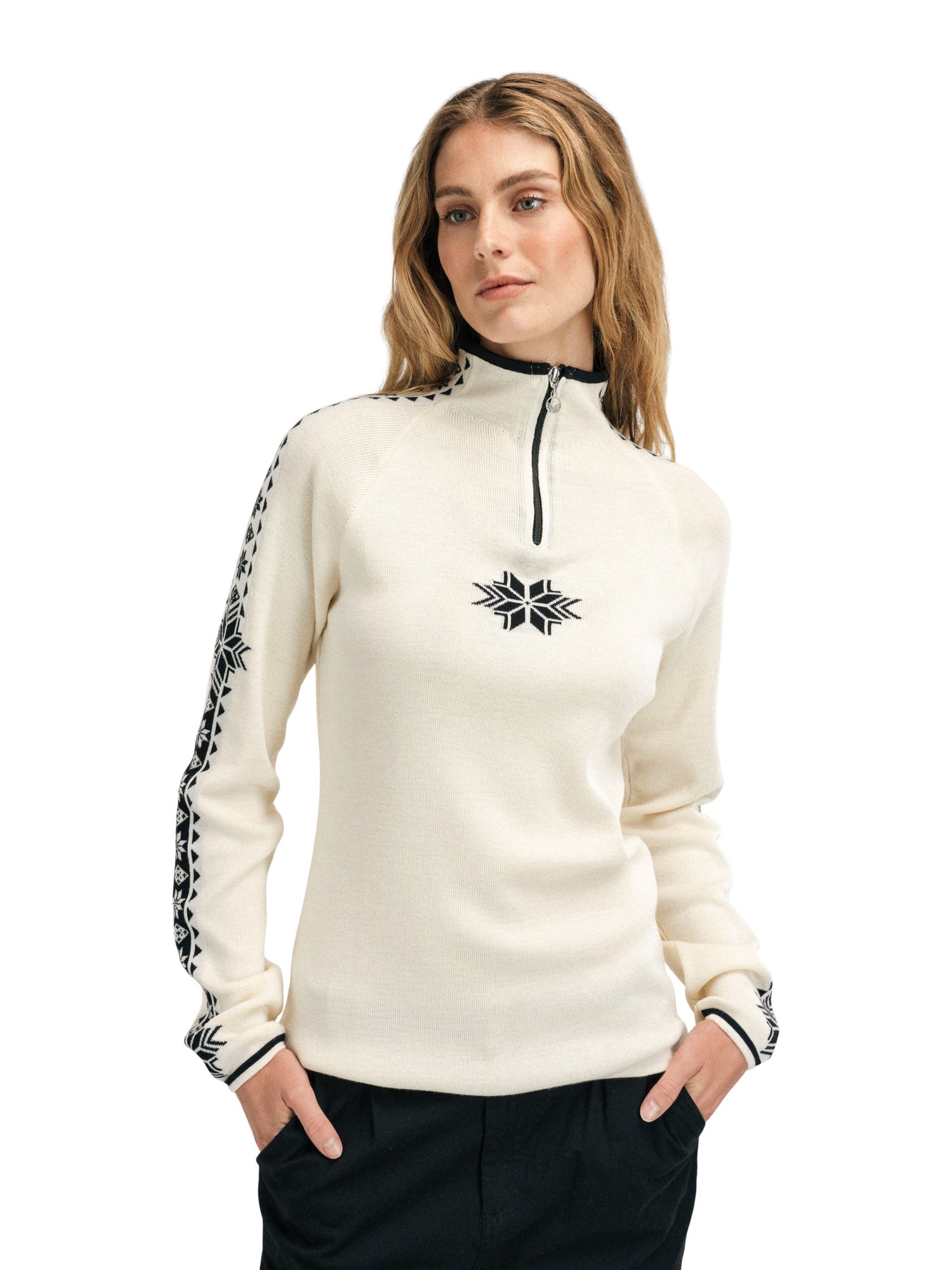 A woman wearing a white Dale of Norway Women’s Geilo turtleneck sweater made in Norway from luxurious Norweigan merino wool.