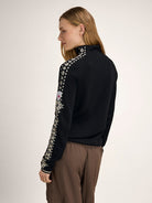 Dale of Norway Women's Geilo Sweater in Black Offwhite, a slim-fit quarter-zip sweater made from 100% skin-soft merino wool.