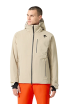 Front view of a sand beige Descente Men's Josh Jacket featuring 4-way stretch Dermizax fabric, minimal seam construction, heat-sealed chest pocket, and underarm zip ventilation.
