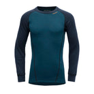 A blue and navy Devold Junior Active Merino Shirt designed for kids made from moisture-wicking, lightweight, and warm merino wool.