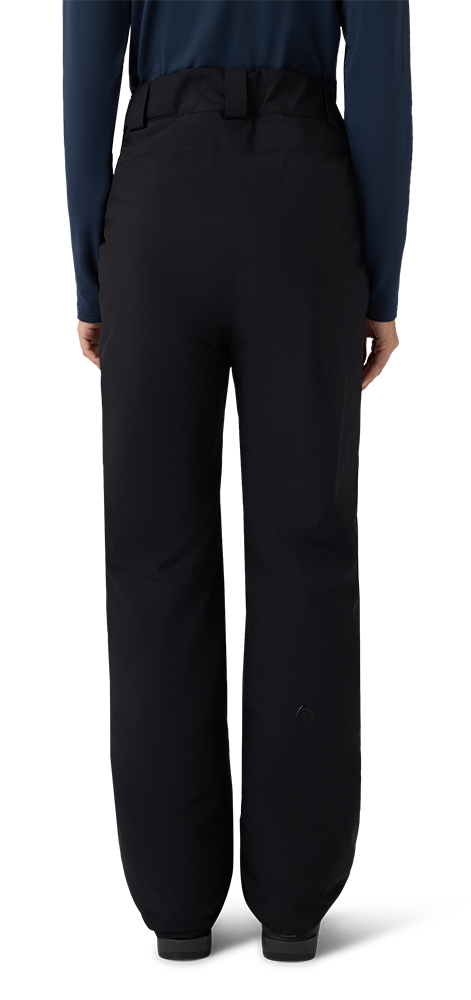 A pair of black Head Women’s Joy Pants showing waterproof breathable shell fabric, articulated knee construction, fully taped seams, adjustable waistband, side zippered pockets, and reinforced scuff guards at lower leg hems.