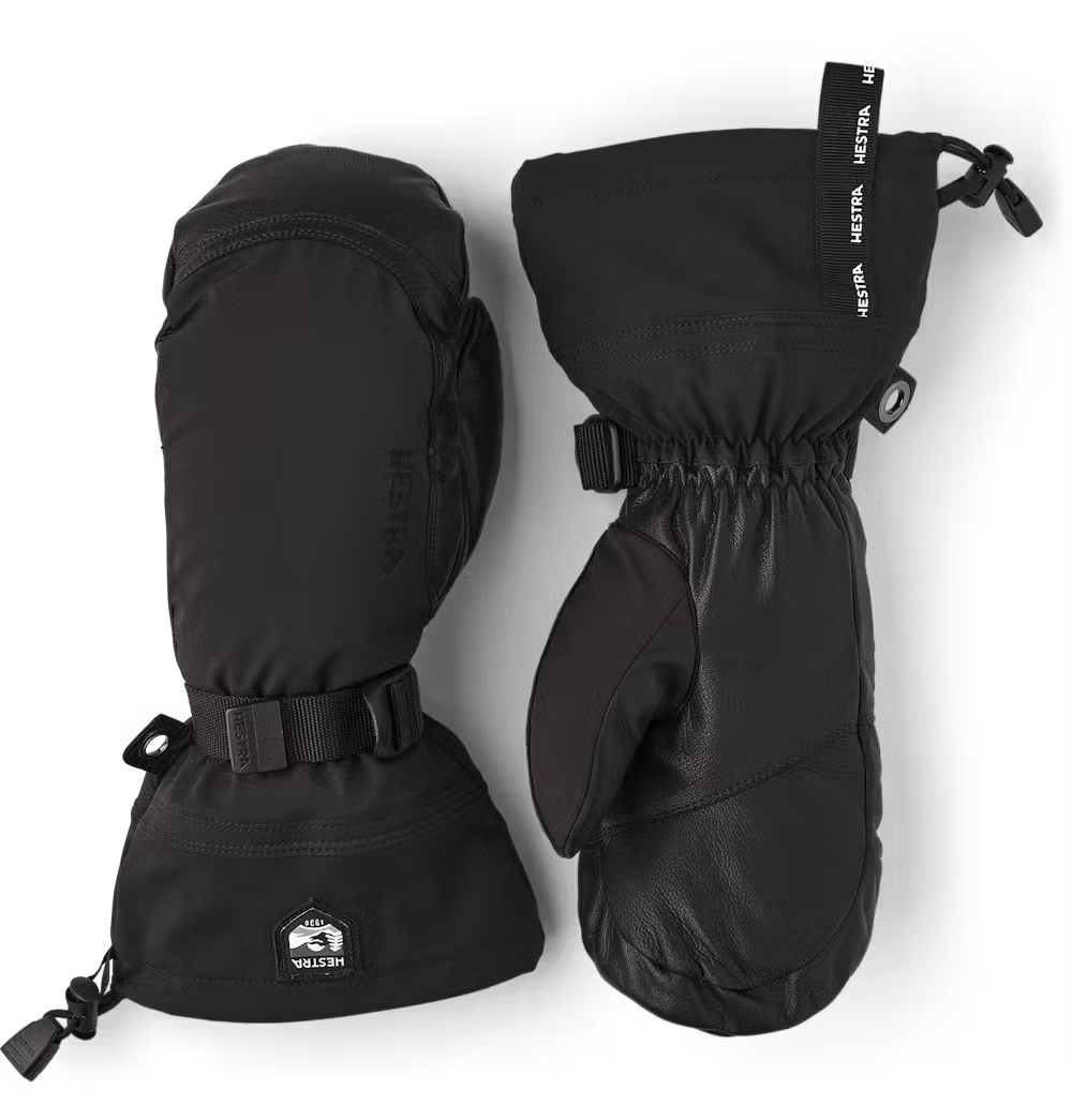 A pair of black Hestra Army Leather Extreme Mittens, which are designed to keep your hands warm and dry in harsh winter conditions.