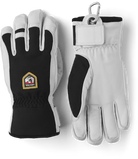 A pair of black and white Hestra Army Leather Patrol gloves that are designed to keep your hands warm and dry in harsh winter conditions.