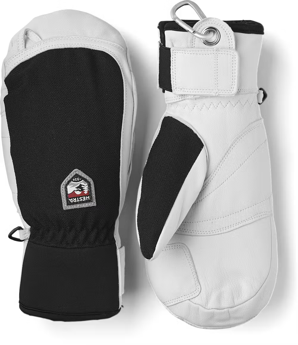 A pair of black and white Hestra Army Leather Patrol Mittens that are designed to keep your hadns warm and dry in harsh winter conditions.