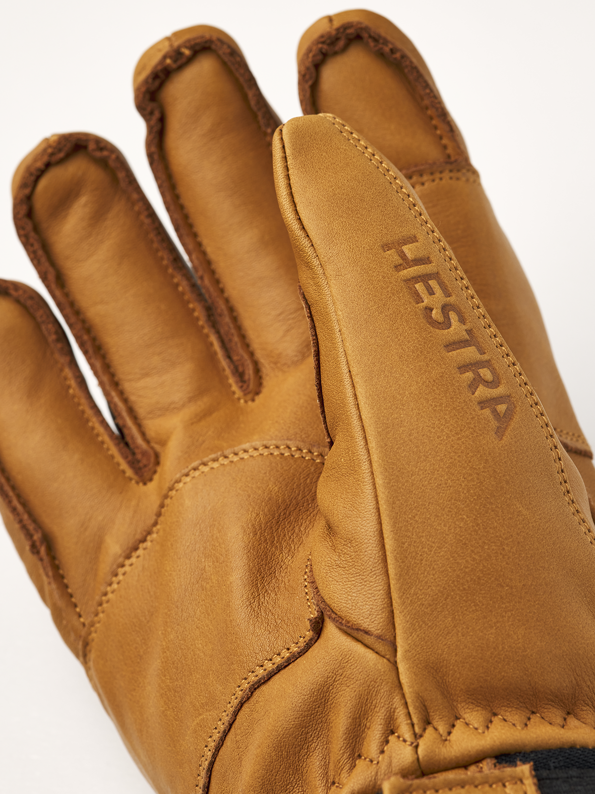 A close-up of a brown leather Hestra Fall Line Glove that is made from premium materials.