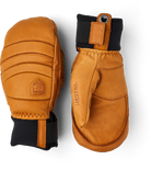 A pair of brown leather Hestra Fall Line Mittens made from premium materials.