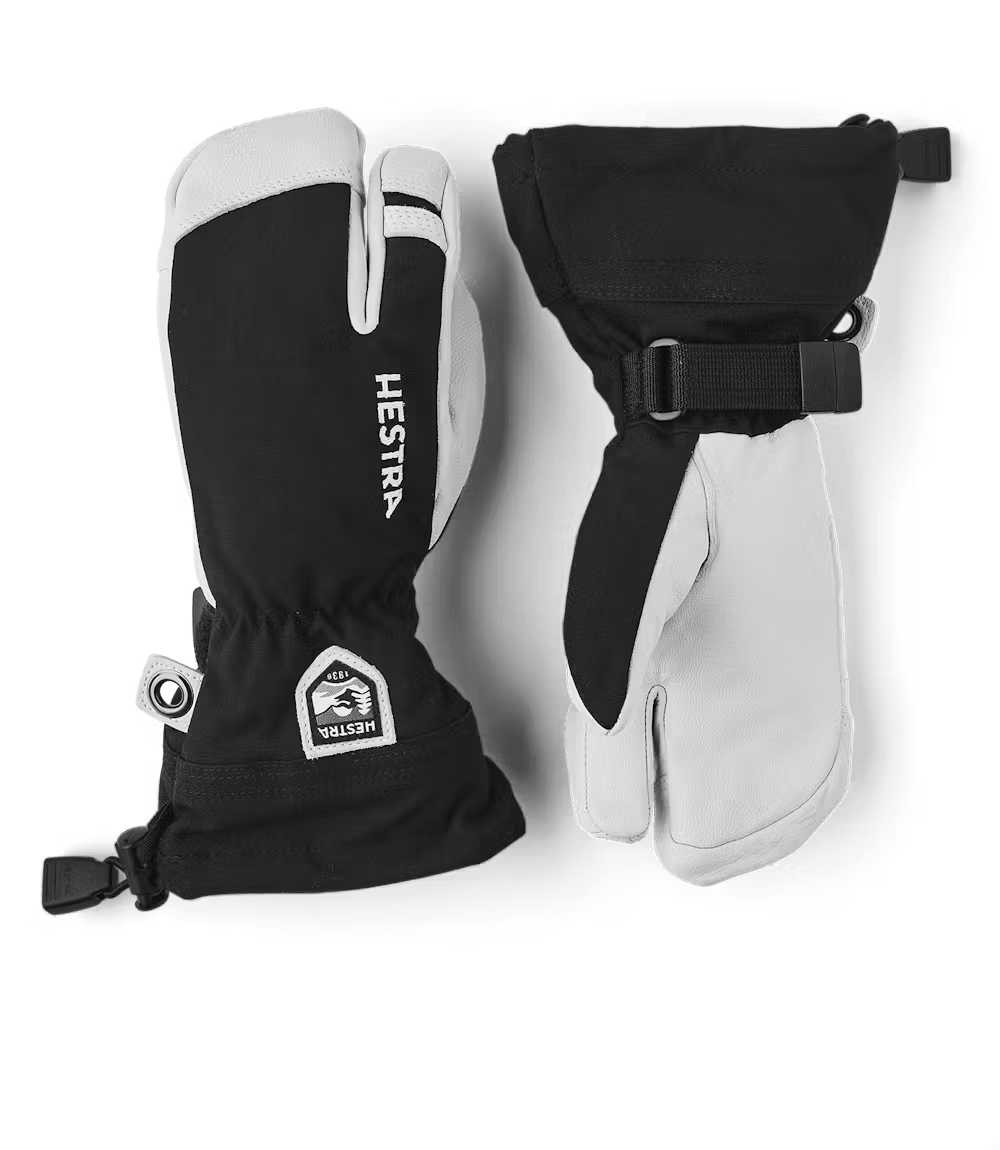 A pair of black and white Hestra Jr Heli Ski 3-Finger Gloves that are designed to keep your child's hands warm and dry in harsh winter conditions.