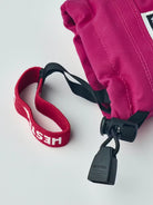 A pair of pink Hestra Junior Army Leather Heli Ski Mittens that are designed to keep your child's hands warm and dry in harsh winter conditions.