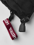 A close-up of the wrist of a black and white Hestra Junior Army Leather Heli Ski Mitten that is made from premium leather.