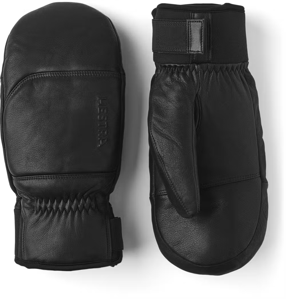 A pair of black leather Hestra Omni Mittens that are designed to keep your hands warm and dry in harsh winter conditions.
