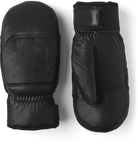 A pair of black leather Hestra Omni Mittens that are designed to keep your hands warm and dry in harsh winter conditions.