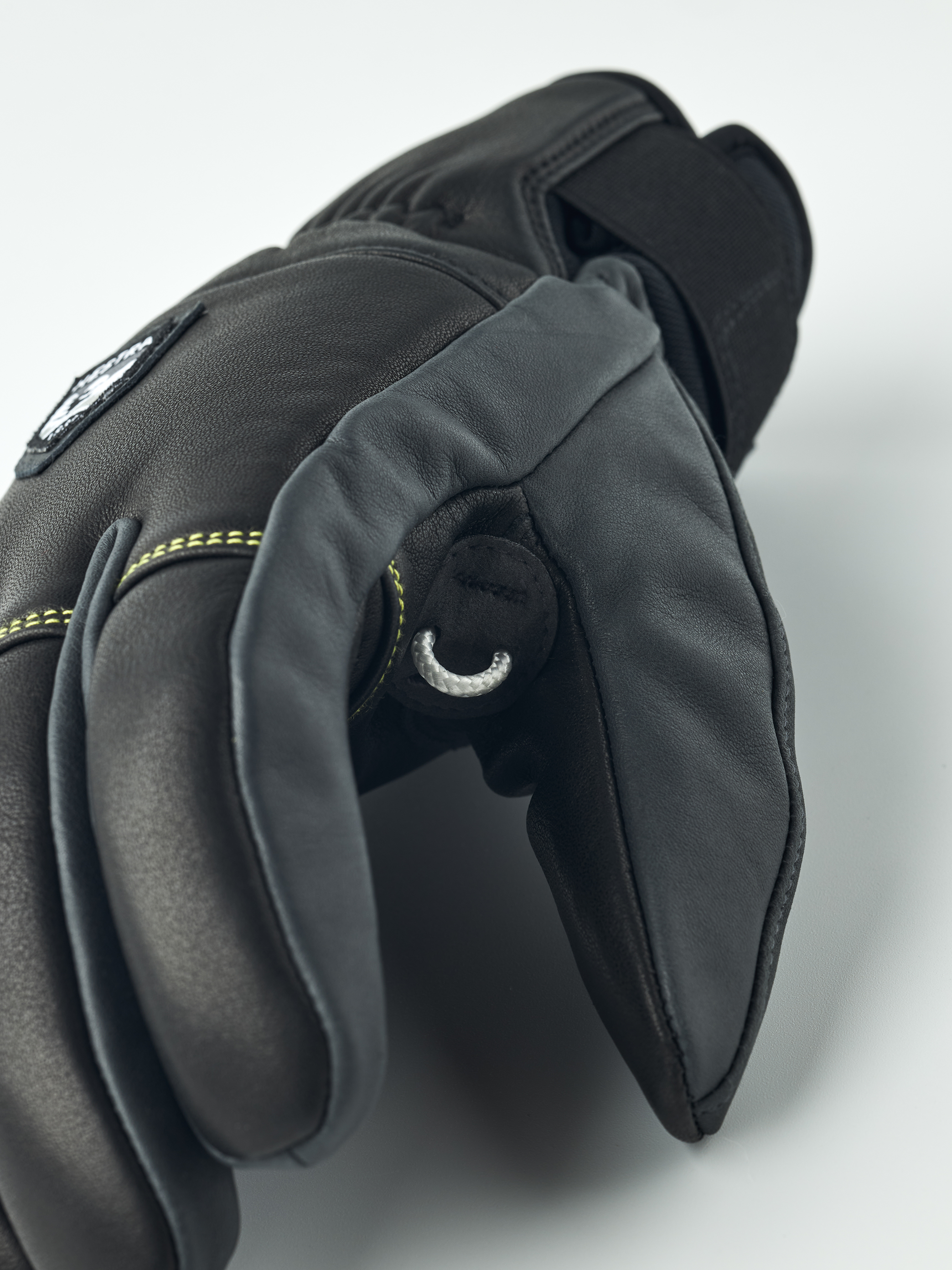 A pair of black Hestra Omni Trigger Gloves that are made from premium leather and feature a trigger loop for Leki Ski Poles.