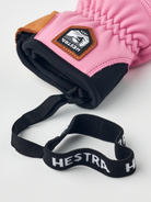 A pink Hestra Women's Fall Line Glove that is made from premium leather.