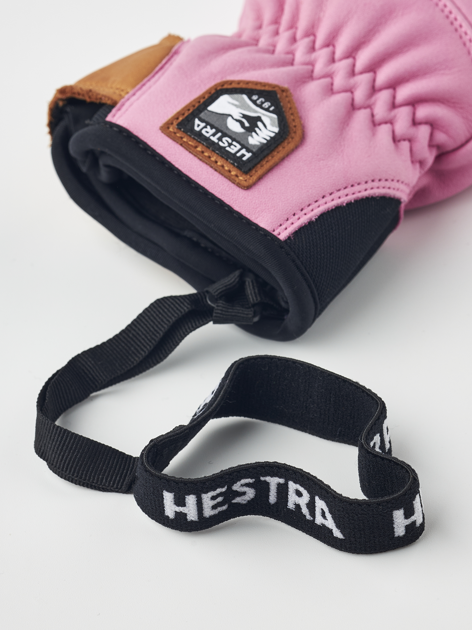 A pink Hestra Women's Fall Line Glove that is made from premium leather.