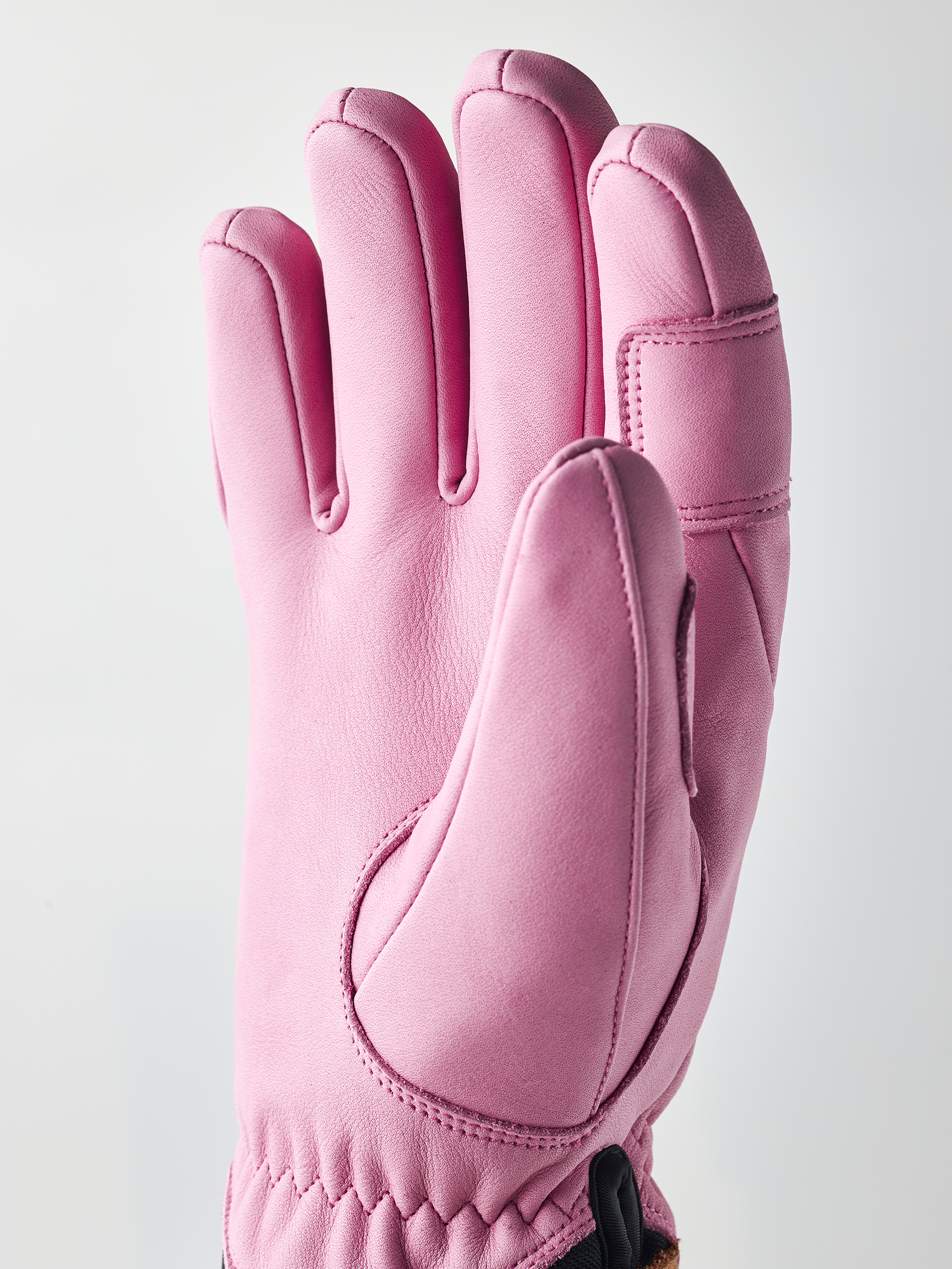 A pink Hestra Women's Fall Line Glove that is made from premium leather.
