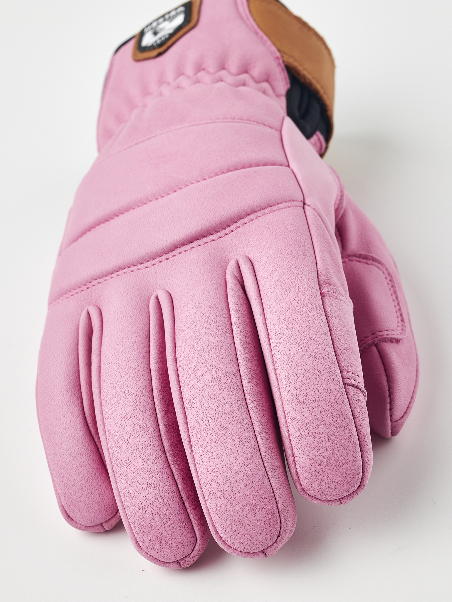 A pink Hestra Women's Fall Line Glove that is made from premium leather.