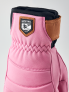 A pink Hestra Women's Fall Line Glove that is made from premium leather.