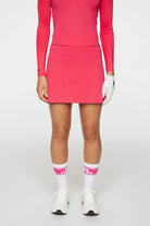 J.Lindeberg Women's Amelie Mid golf skirt with built-in shorts and breathable stretch performance fabric for golf and resort wear