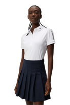 J.Lindeberg Women's Tour Tech golf polo with breathable four-way stretch performance fabric and athletic fit for golf and active wear