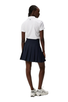 J.Lindeberg Women's Tour Tech golf polo with breathable four-way stretch performance fabric and athletic fit for golf and active wear
