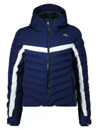 A navy blue Kjus Girls Mila Ski Jacket that features 20K waterproofing and breathability, premium 4-way stretch fabric, a powder skirt, and a detachable hood.