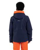 Rear view of a blue Kjus Jr Boys’ Formula Jacket featuring 4-way stretch waterproof fabric, Fast Thermo Core insulation, water-repellent zippers, and the KJUS-GROW sleeve extension system.