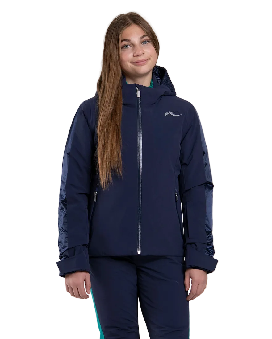 Front view of an Atlanta blue Kjus Jr Girls’ Snowfall Jacket featuring 4-way stretch waterproof fabric, Fast Thermo Core insulation, water-repellent zippers, and the KJUS-GROW sleeve extension system.