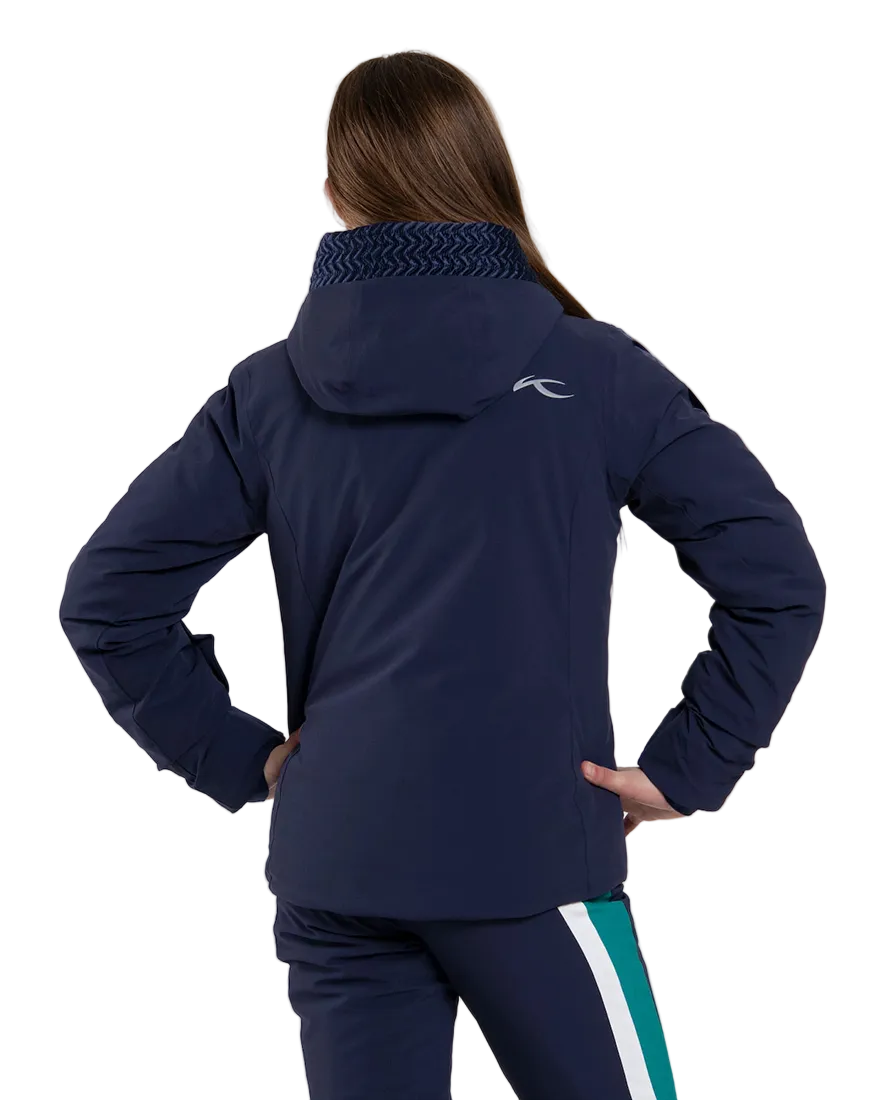 Rear view of an Atlanta blue Kjus Jr Girls’ Snowfall Jacket featuring 4-way stretch waterproof fabric, Fast Thermo Core insulation, water-repellent zippers, and the KJUS-GROW sleeve extension system.