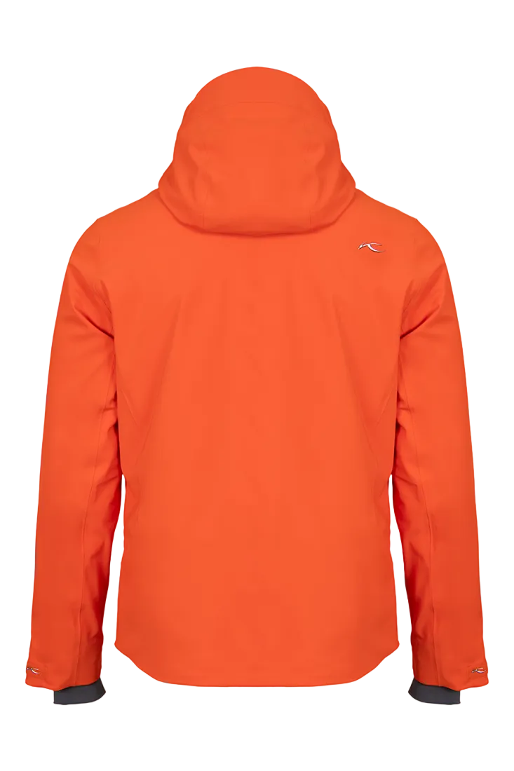 Rear view of an orange Kjus Men’s Formula Jacket featuring 4-way stretch waterproof fabric, Fast Thermo Core insulation, water-repellent zippers, AC-Vent forearm ports, and a detachable helmet-compatible hood.