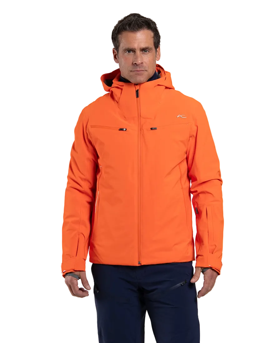 Front view of an orange Kjus Men’s Formula Jacket featuring 4-way stretch waterproof fabric, Fast Thermo Core insulation, water-repellent zippers, AC-Vent forearm ports, and a detachable helmet-compatible hood.