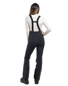 Rear view of black Kjus Women’s Core Embrace Pants featuring 4-way stretch waterproof fabric, high-efficiency thermal insulation, water-repellent zippers, reinforced scuff guards, and internal snow gaiters.